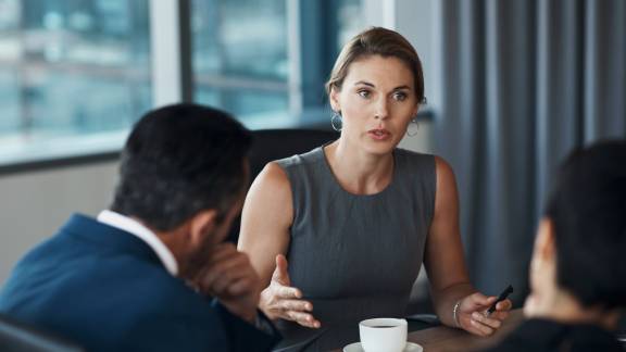 Conversation between a woman and a man in a meeting.