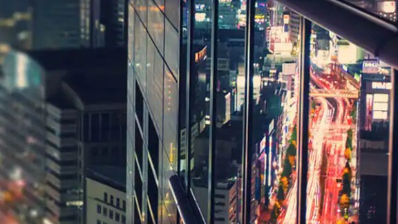 Reflection of a cityscape on a glass of a building