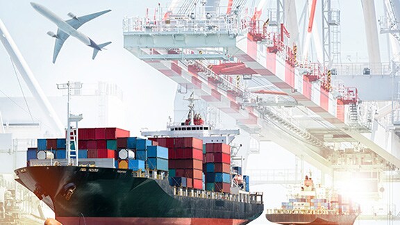 A full cargo ship and a plane leaving a loading dock
