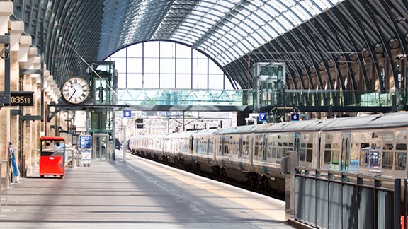 An empty railway platform with train passing through