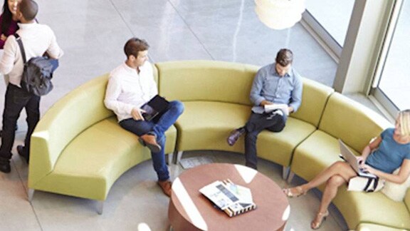 Employees sitting in the lobby of a commercial building