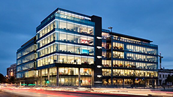 A commercial building lit-up during night-time