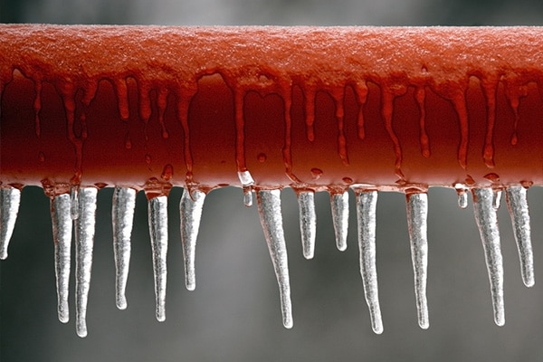 Close-up of icicles on a fire sprinkler pipe