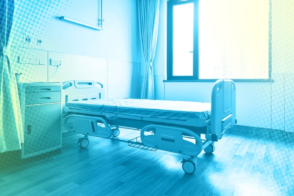 An empty hospital chamber, with a bed