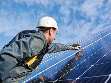 technician installing solar panel