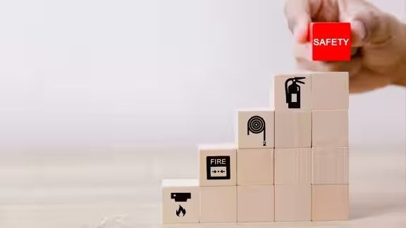 Stack of wooden blocks with graphics depicting fire safety measures