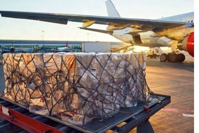 Packed shipments in front of an airplane