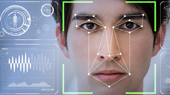 Close-up of a man's face with an overlay of facial recognition graphics