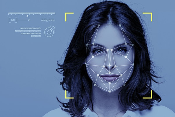 Close-up of a woman's face with an overlay of facial recognition graphics
