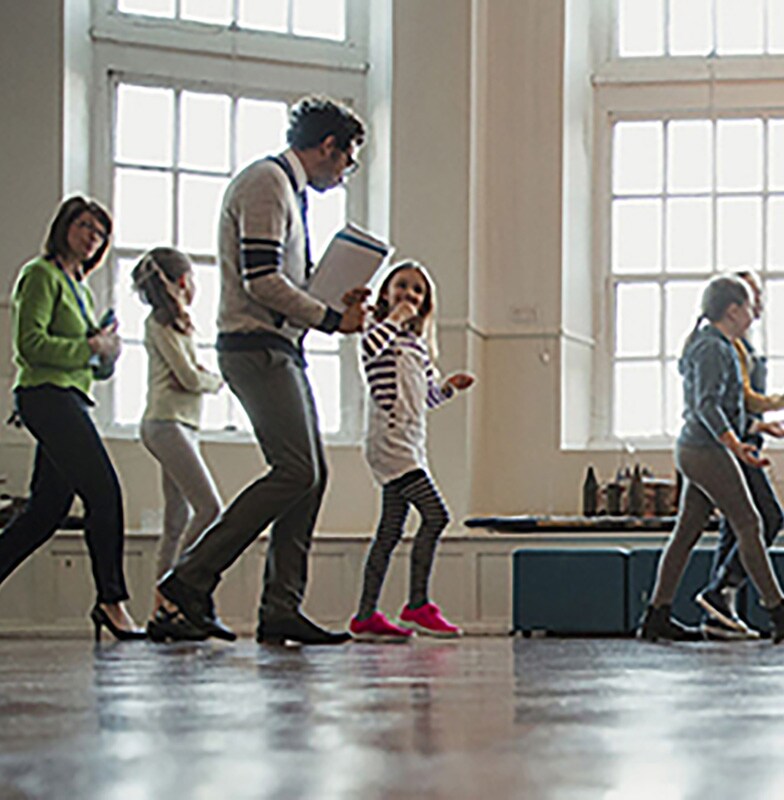 Two instructors walking with a group of kids