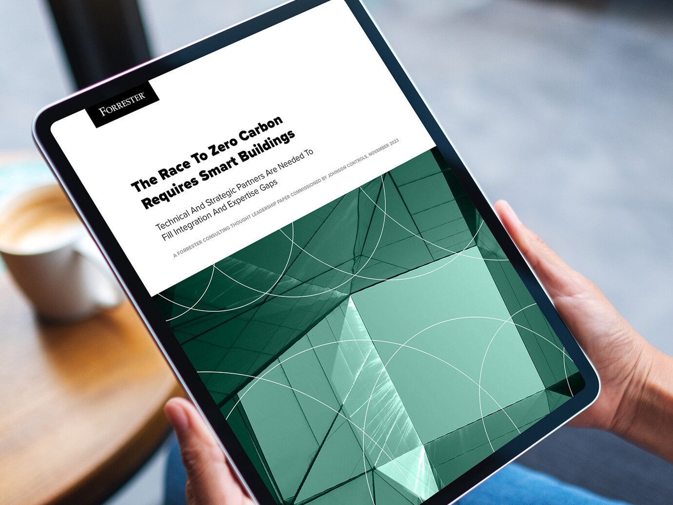 A tablet screen displaying The race to zero carbon requires smart buildings whitepaper