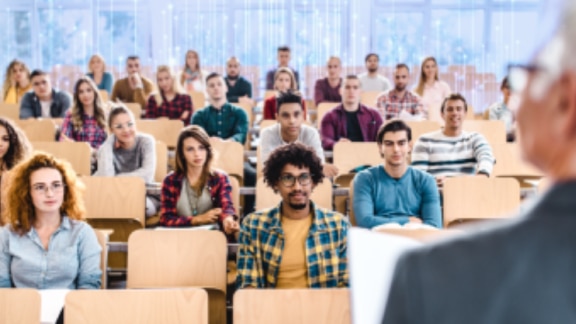 University students listening to a professor's lecture
