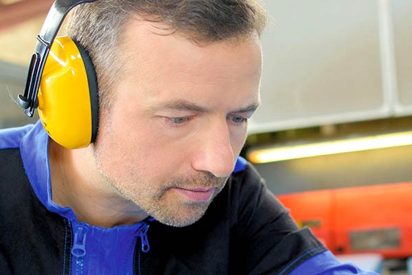 A man wearing headphones looking down