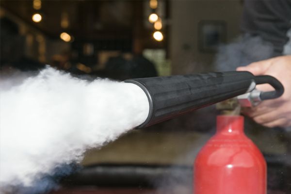 Carbon dioxide shooting out of a fire extinguisher nozzle