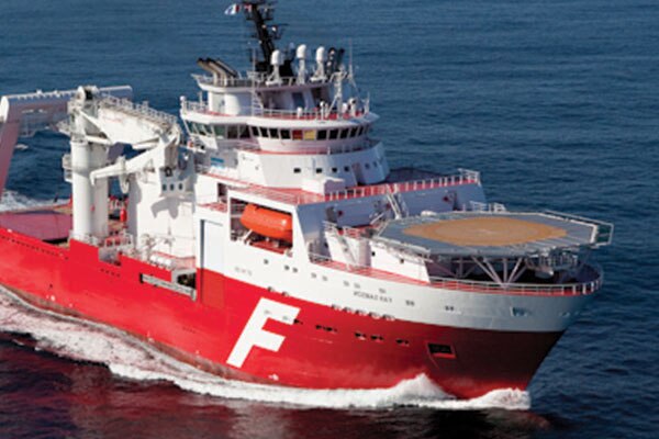 An industrial ship with a helipad in the ocean