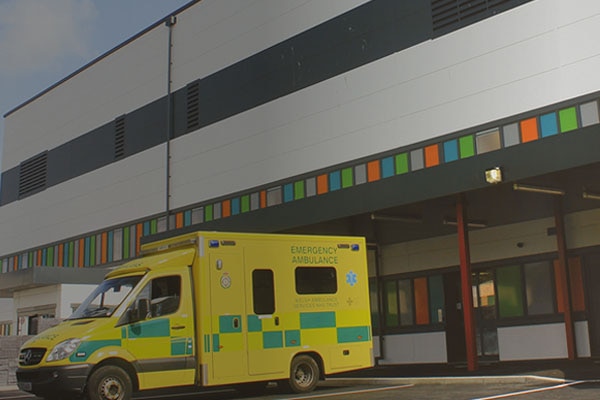 An ambulance parked in front of a hospital building